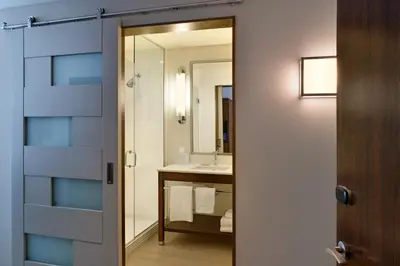 a bathroom with a sink and a mirror at Four Points by Sheraton Coral Gables in Miami