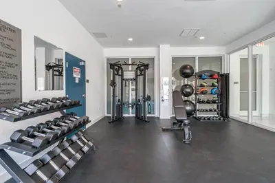 a gym with several treadmills and weights at Resort-Style 1 Bed Condo with Pool Parking Rooftop & Gym in Hollywood