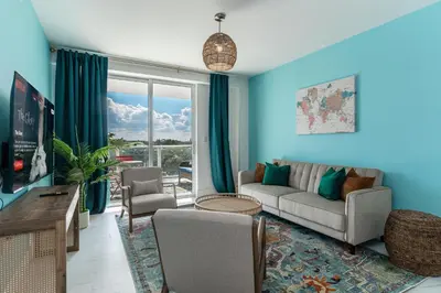 a living room with blue walls and a couch at Resort-Style 1 Bed Condo with Pool Parking Rooftop & Gym in Hollywood