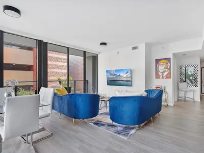 a living room with blue chairs and a table at X Lounge III-Modern Corner Residence in Miami