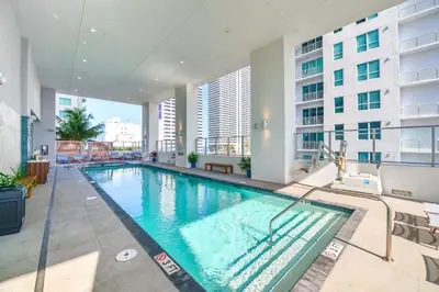 an indoor swimming pool in a building with a building at Great Miami Stay Steps from Bayside & the Beach in Miami