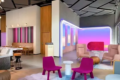 a waiting room with purple chairs and tables at Great Miami Stay Steps from Bayside & the Beach in Miami