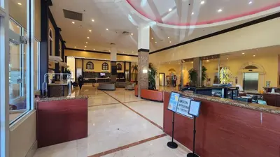 a restaurant with a bar in the middle of a building at Stunning Beachfront condo in sunny Sunny Isles Beach with AC, fitness room, WiFi in Sunny Isles Beach