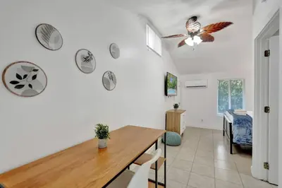 a dining room with a table and birds on the wall at Tropical Oasis Studio w Pool in Fort Lauderdale