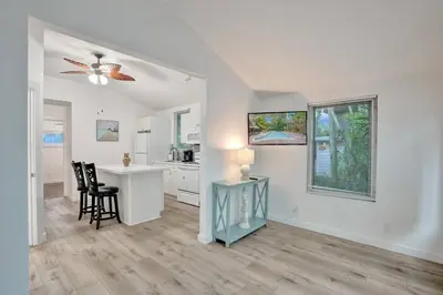a living room with a desk and a kitchen at Tropical Oasis 2BR w Pool in Fort Lauderdale