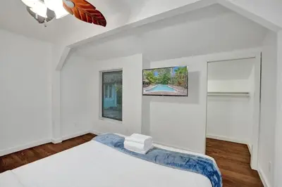 a white bedroom with a bed and a window at Tropical Oasis 2BR w Pool in Fort Lauderdale