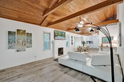 a living room with a white couch and a fireplace at Tropical Oasis 2BR House w Pool in Fort Lauderdale