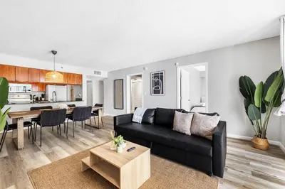 a living room with a black couch and a table at Enjoy of Beautiful City Views From This Condo in Miami