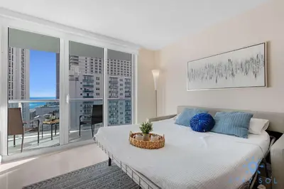 a bedroom with a bed and a large window at Stylish Ocean Apartment with Pool in Hollywood