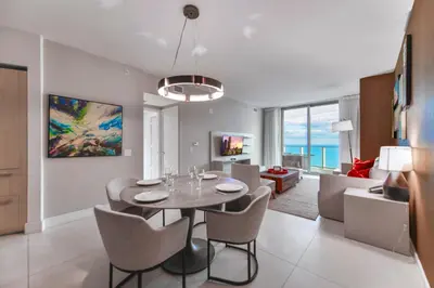 a dining room and living room with a table and chairs at Condo Closer The Sea and Beatiful Views in Hollywood