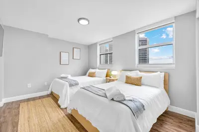 two beds in a room with two windows at The Best Amenities In One-Site in Miami