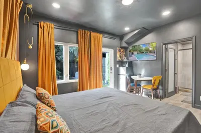 a bedroom with a large bed and a table at Kiki 4 - Men's Clothing optional Guest Houses in Fort Lauderdale
