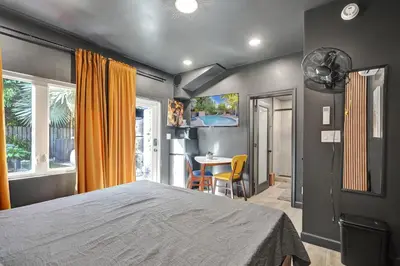 a bedroom with a bed and a table with chairs at Kiki 4 - Men's Clothing optional Guest Houses in Fort Lauderdale