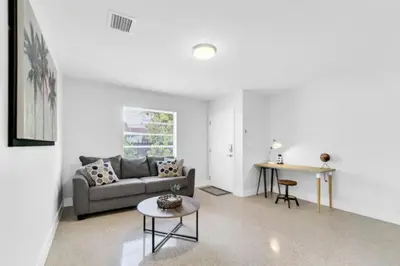 a living room with a couch and a table at Fab 4BR Twin Villas Near Design District and Wynwood in Miami