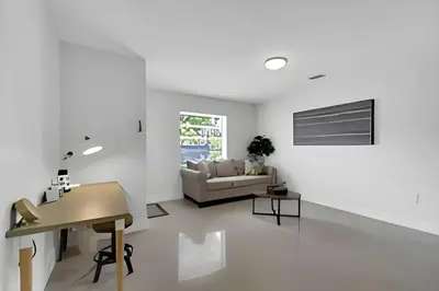 a white living room with a couch and a table at Fab 4BR Twin Villas Near Design District and Wynwood in Miami