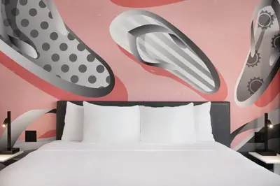 a bedroom with a bed and shoes on the wall at Kompose Boutique Miami Airport in Miami