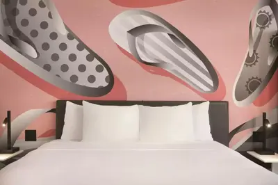 a bedroom with a bed and shoes on the wall at Kompose Boutique Miami Airport in Miami