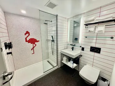 a bathroom with a shower and a toilet and a sink at Kompose Boutique Miami Airport in Miami