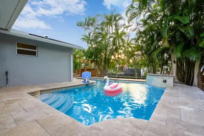 a swimming pool with a pool toy in a house at Waterfront House - Solar Heated Pool, Arcade Games in Fort Lauderdale