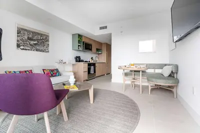 a living room with purple chairs and a table at RumRunner - Hotel style amenities in the heart of Miami in Miami