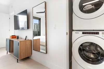 a bathroom with a washing machine and a mirror at RumRunner - Hotel style amenities in the heart of Miami in Miami