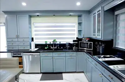 a blue kitchen with a sink and a microwave at New! Upscale Modern waterfront apartment 3BR 3BA in Miami