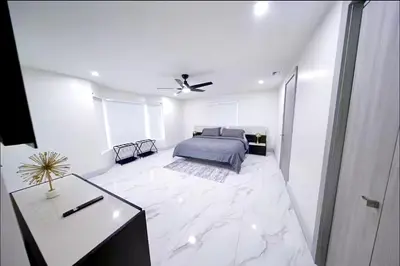a large white bedroom with a bed and a table at New! Upscale Modern waterfront apartment 3BR 3BA in Miami