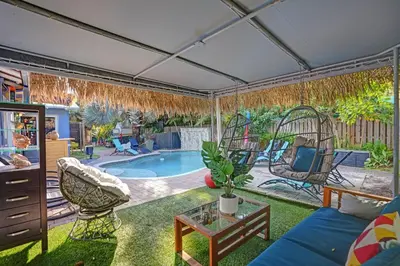 a living room with a patio with a swimming pool at Kiki 5 - Men's Clothing optional Guest Houses in Fort Lauderdale