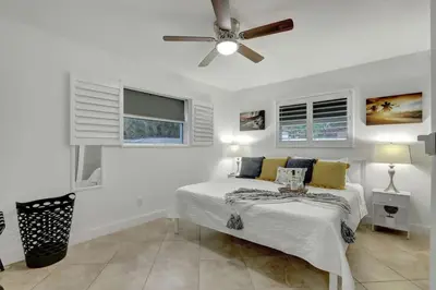 a bedroom with a bed and a ceiling fan at Relaxing Retreat 2BR Oasis with Pool and Outdoor BBQ in Pembroke Pines