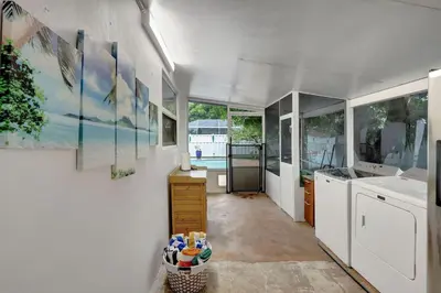 a kitchen with white cabinets and a sink at Relaxing Retreat 2BR Oasis with Pool and Outdoor BBQ in Pembroke Pines