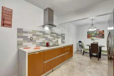 a kitchen with a counter and a table in it at Relaxing Retreat 2BR Oasis with Pool and Outdoor BBQ in Pembroke Pines