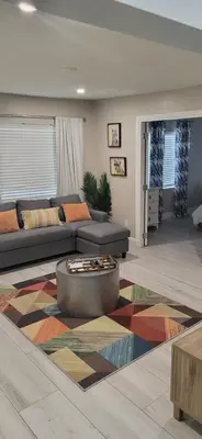 a living room with a couch and a rug at Sunny Cottage in Fort Lauderdale