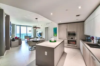 a kitchen and living room with a view of the ocean at Level Up in This Condo w Breathtaking Views! in Hollywood