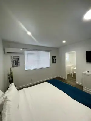 a bedroom with a large white bed and a window at Tranquil Studio W Parking 10 min to Beach FLL in Hollywood