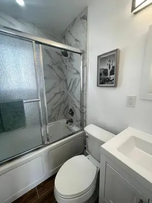 a bathroom with a toilet and a shower and a sink at Modern Studio W Parking 10 min to FLL and Beach in Hollywood