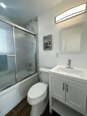a bathroom with a toilet and a sink and a shower at Modern Studio W Parking 10 min to FLL and Beach in Hollywood