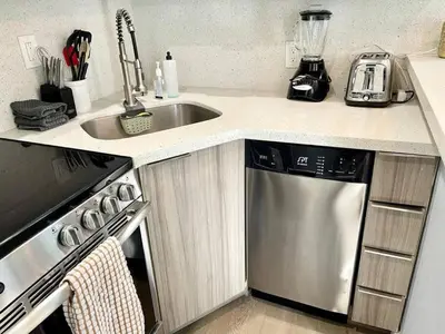 a kitchen with a sink and a dishwasher at Serene Studio W Parking 10 min from Beach and FLL in Hollywood