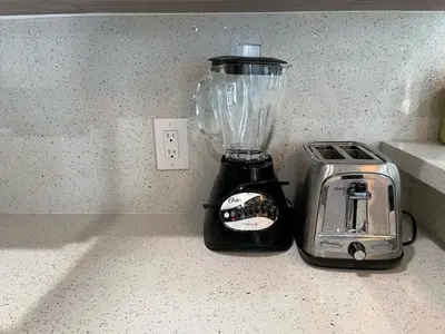 a blender sitting on a counter next to a toaster at Serene Studio W Parking 10 min from Beach and FLL in Hollywood