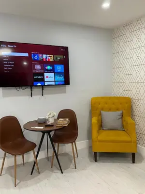 a dining room with a yellow chair and a table at Apartament Miami Design District in Miami