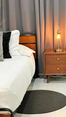 a bedroom with a bed and a nightstand with a lamp at Apartament Miami Design District in Miami