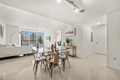 a white living room with a table and chairs at Magnificent Unit with Priceless Views W Icon in Miami