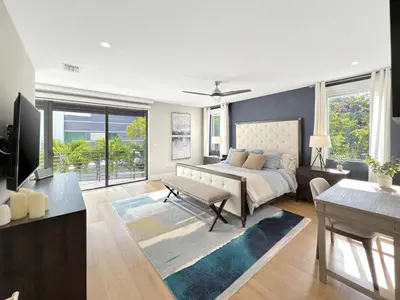 a bedroom with a bed and a living room at Lux 4BR Retreat with Heated Pool, BBQ, and Bikes in Miami