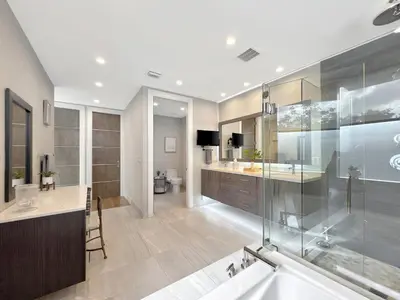 a bathroom with a tub and a sink and a shower at Lux 4BR Retreat with Heated Pool, BBQ, and Bikes in Miami