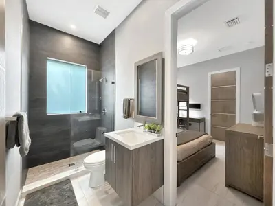 a bathroom with a sink and a toilet and a shower at Lux 4BR Retreat with Heated Pool, BBQ, and Bikes in Miami