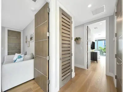 a hallway with a sliding barn door in a house at Lux 4BR Retreat with Heated Pool, BBQ, and Bikes in Miami