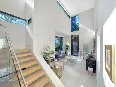 a staircase in a house with a living room at Lux 4BR Retreat with Heated Pool, BBQ, and Bikes in Miami
