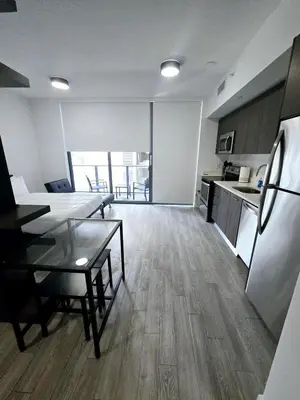 a kitchen and living room with a table and a refrigerator at Miami Myami Miamí Studio Apartment with Balcony in Miami