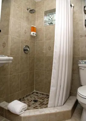 a shower with a shower curtain and a toilet at Welcome to Miami Springs Charm in Miami