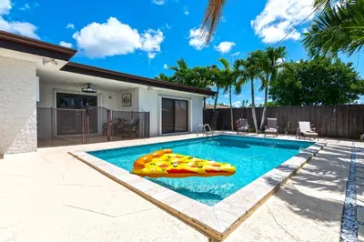 a swimming pool with an inflatablevisor in a backyard at Tropical house Miami in Cutler Bay