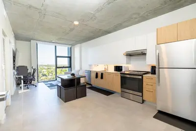 a kitchen with stainless steel appliances and a large window at The Chill Spot in Miami